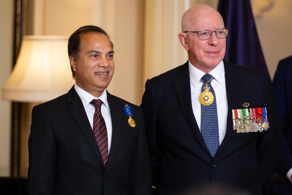 Mainul Haque OAM and Governor-General David Hurley smiling at camera at investiture ceremony