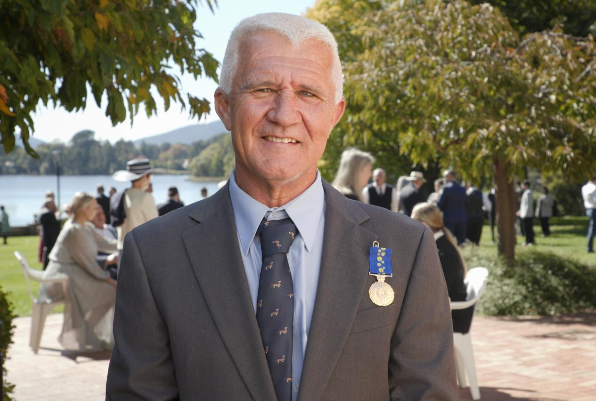 Richard Adams OAM still taken from Investiture Ceremony interview.